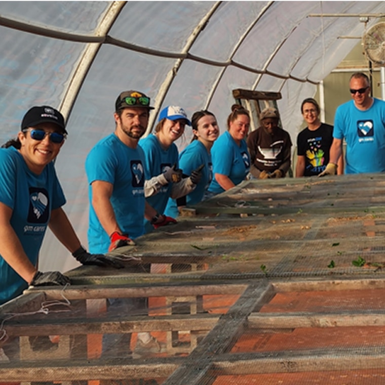 A Group Picture of GM Employees in Blue T-shirts that Volunteered for a GM Cares Event