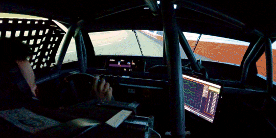 Back Seat View of a Driver Inside a Racecar Using the Track Scanner Screen While Driving
