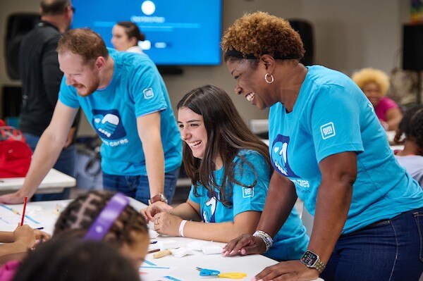 GM employees promoting STEAM Education to students