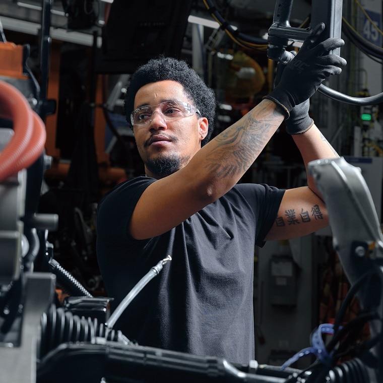 A Behind-the-scenes Shot of a GM Employee Working on a GM Vehicle's Manufacturing