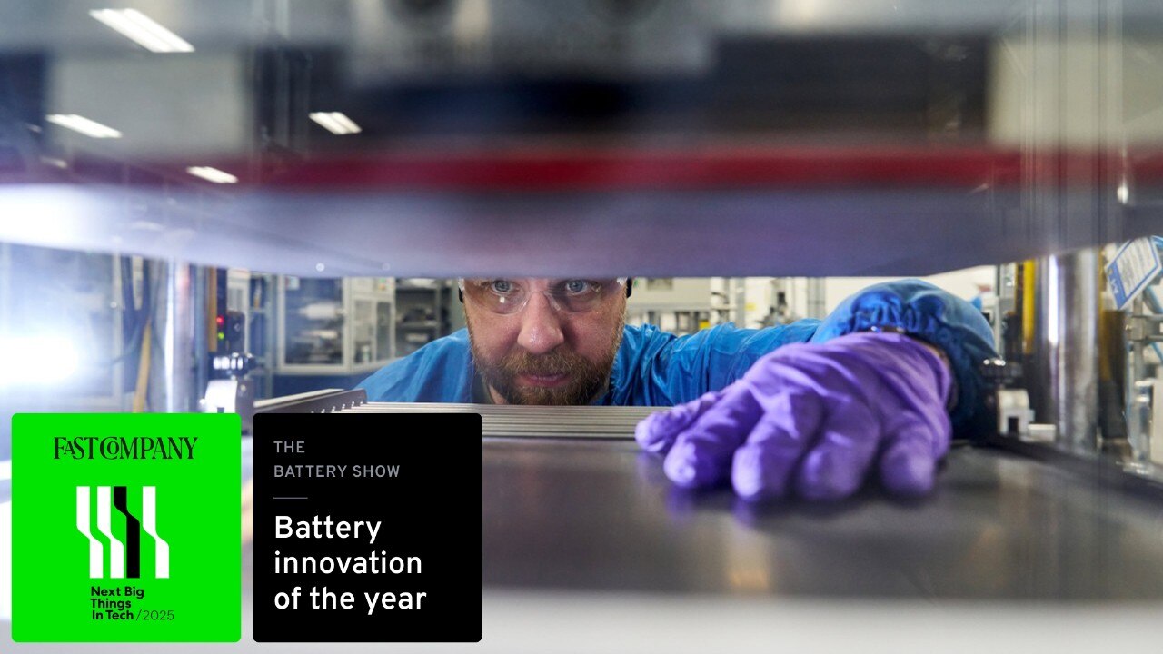 A GM technician works on LMR battery cell, two battery award icons are layered on image.